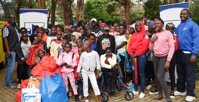 Kayole Children are presented with the early Christmas goodies